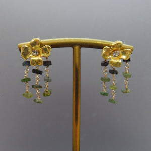 three rows of green tourmalines dangle from gold flower earring posts