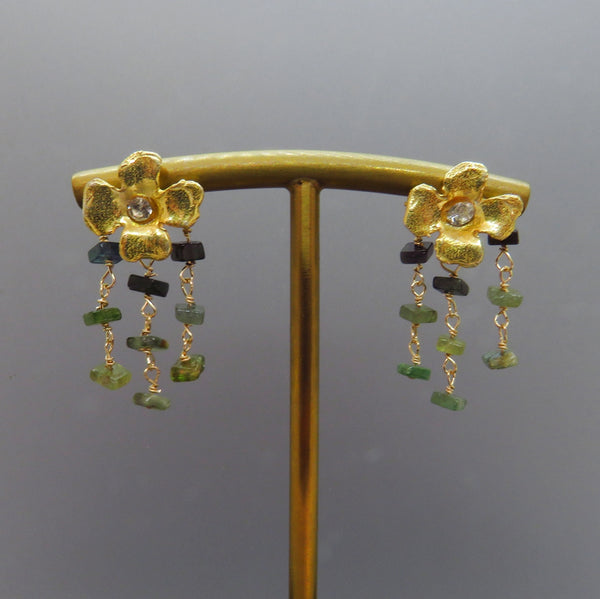 three rows of green tourmalines dangle from gold flower earring posts