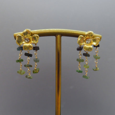 three rows of green tourmalines dangle from gold flower earring posts