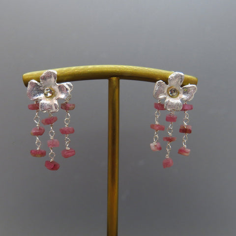 three rows of pink tourmalines dangle from silver flower posts.