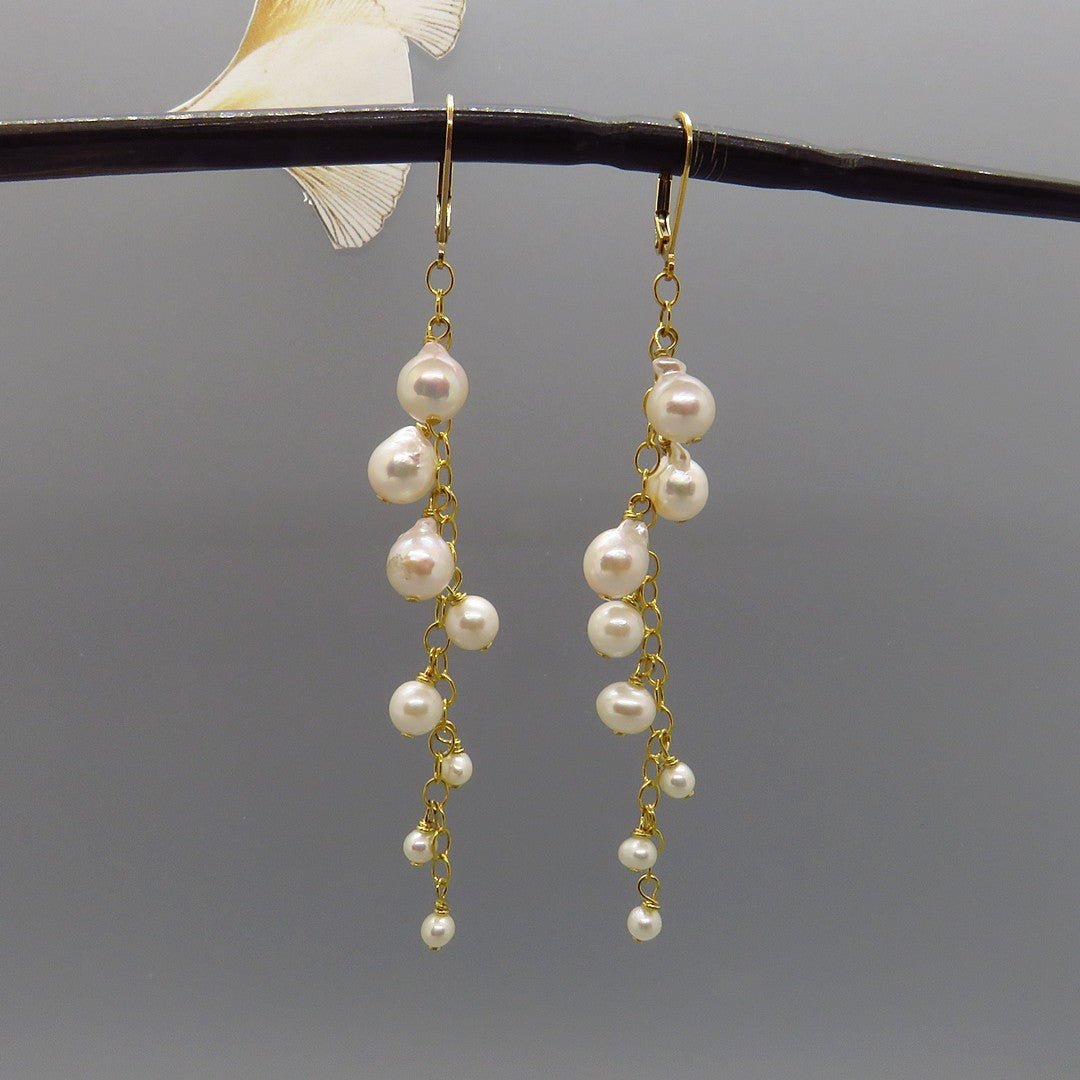 white glowing akoya pearls dangle on gold chain, long dangle, gold leverback