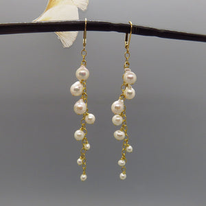 white glowing akoya pearls dangle on gold chain, long dangle, gold leverback