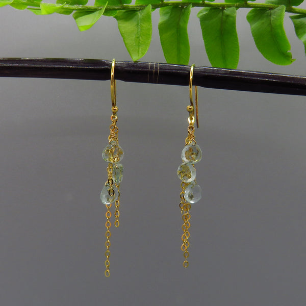 pale aquamarine gemstones dangle on delicate gold chain