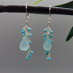 small faceted aqua colored gemstones dangle around aqua chalcedony drops on sterling silver