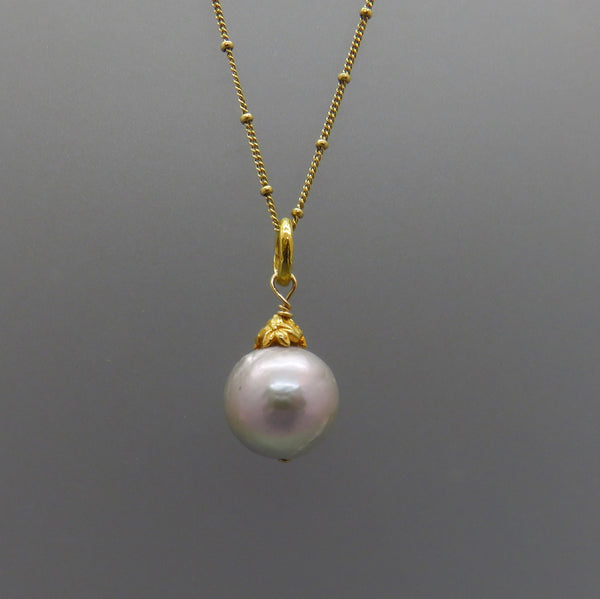 glowing pale gray large pearl with gold flower cap and chain