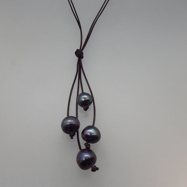 four black peacock pearls on dark brown leather cord lariat style necklace