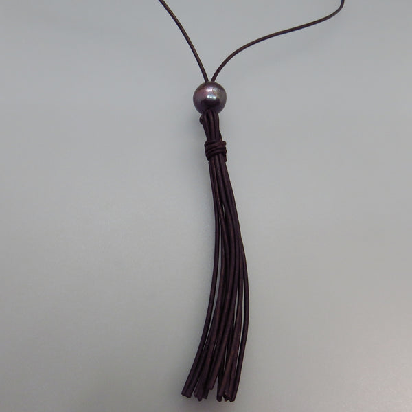 one large black pearl and leather lariat style  necklace with leather tassel