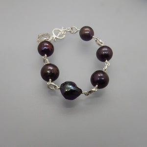 bracelet with six large black peacock pearls, silver links, silver toggle clasp and small heart charm