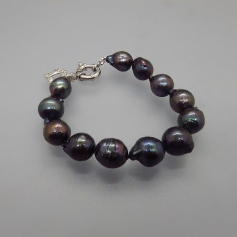 bracelet with large black peacock pearls, hand knotted on silk cord, silver toggle clasp