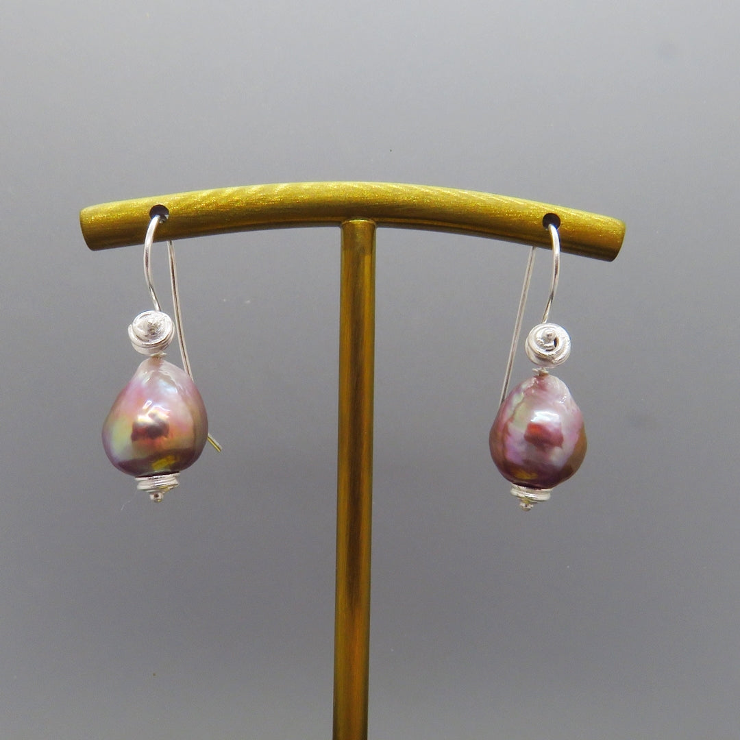 glowing lavender pink baroque pearl earings with swirl design silver ear wires 