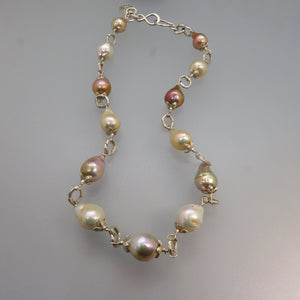 glowing pink and white drop shape pearls with silver caps and links and hook clasp necklace