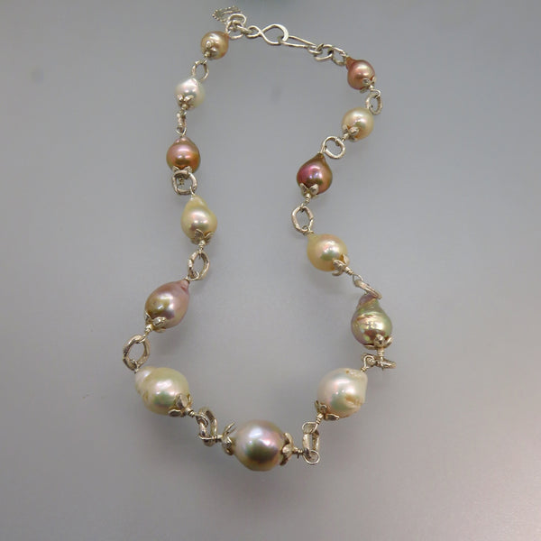 glowing pink and white drop shape pearls with silver caps and links and hook clasp necklace