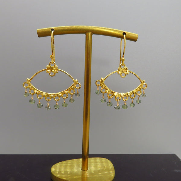 tiny green sapphires dangle from gold chandeliers