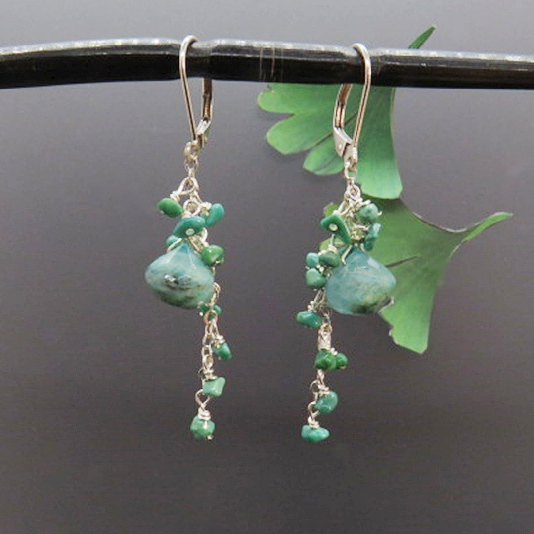 turquoise gemstones dangle on silver chain 