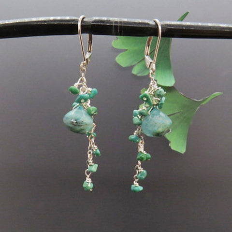 turquoise gemstones dangle on silver chain 