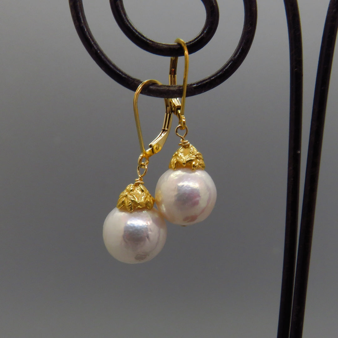 Glowing white Edison pearl earrings with gold vermeil caps and gold lever back ear wires 