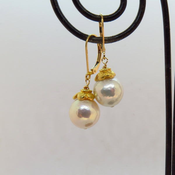 luminous creamy white edison pearls, capped with gold artisan flower caps, gold lever back ear wires