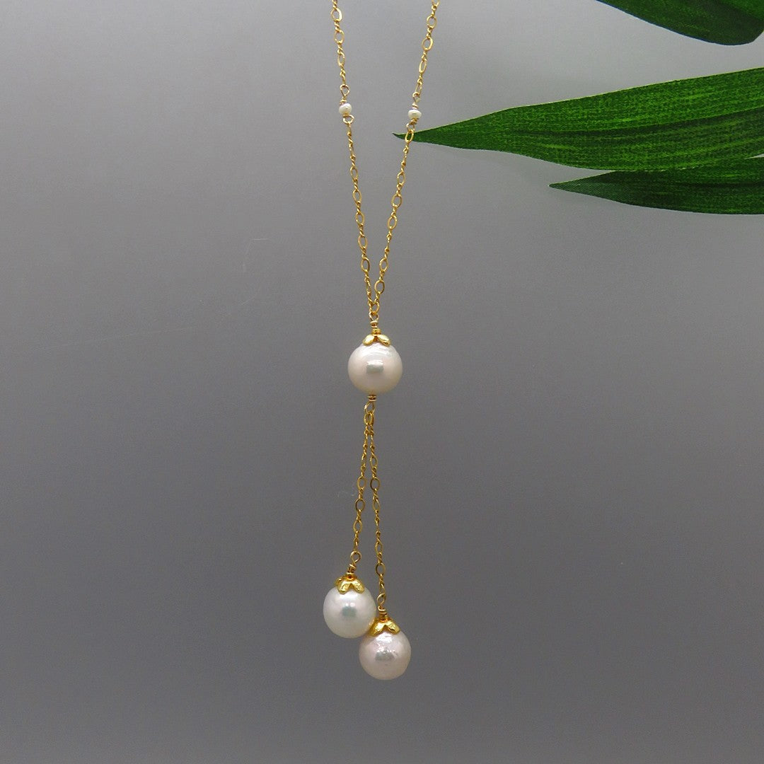 Y necklace with three glowing white pearls with gold vermeil flower caps on gold chain